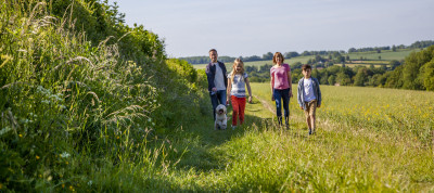 Family walking with dog and view behind